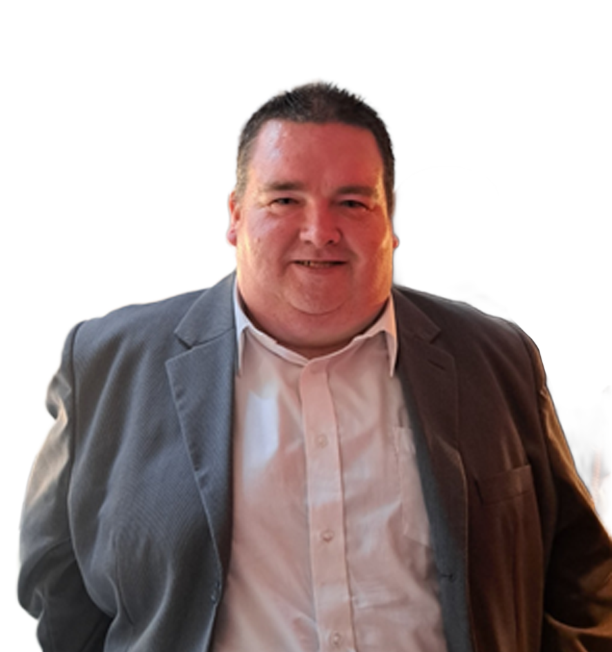 John C, smiling and wearing a grey suit jacket over a white dress shirt
